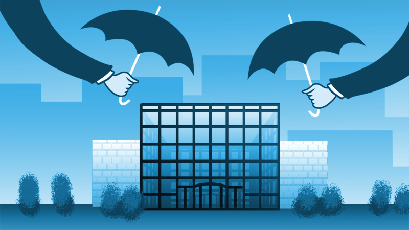 Two umbrellas covering an office building